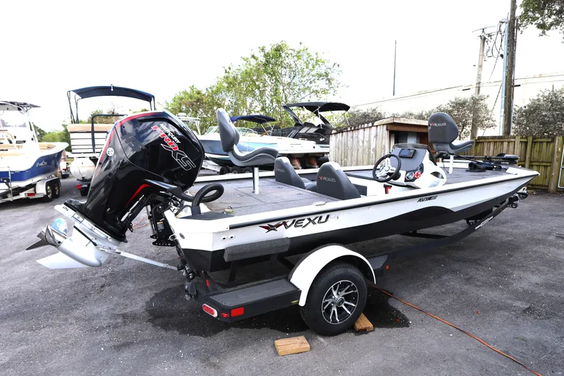 Slide: The Image of 2023 Vexus AVX189 boat with powerful outboard motor, parked on a trailer. - 2