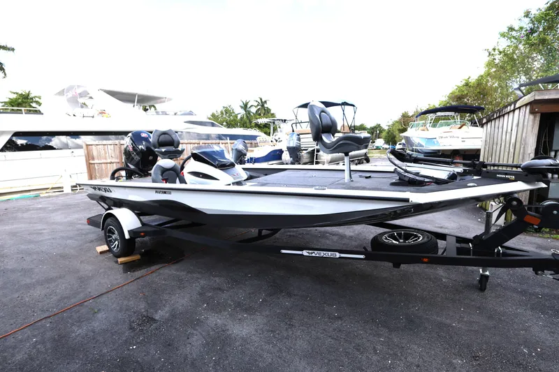 Slide: The Image of 2023 Vexus AVX189 boat on trailer in marina setting. - 3