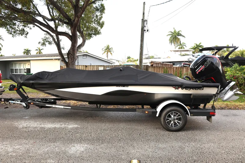 Slide: The Image of 2023 Vexus AVX189 boat on trailer, covered, parked on residential street. - 4