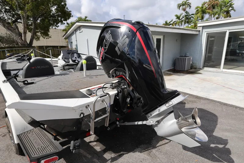 Slide: The Image of 2023 Vexus AVX189 boat with powerful outboard motor, parked outdoors. - 5