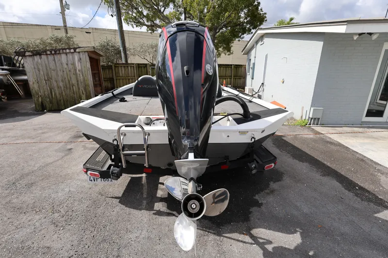 Slide: The Image of 2023 Vexus AVX189 boat with outboard motor, parked outdoors on a sunny day. - 6
