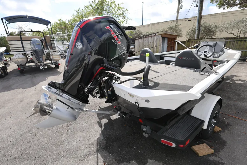 Slide: The Image of 2023 Vexus AVX189 boat with powerful Mercury Pro outboard motor, parked outdoors. - 7