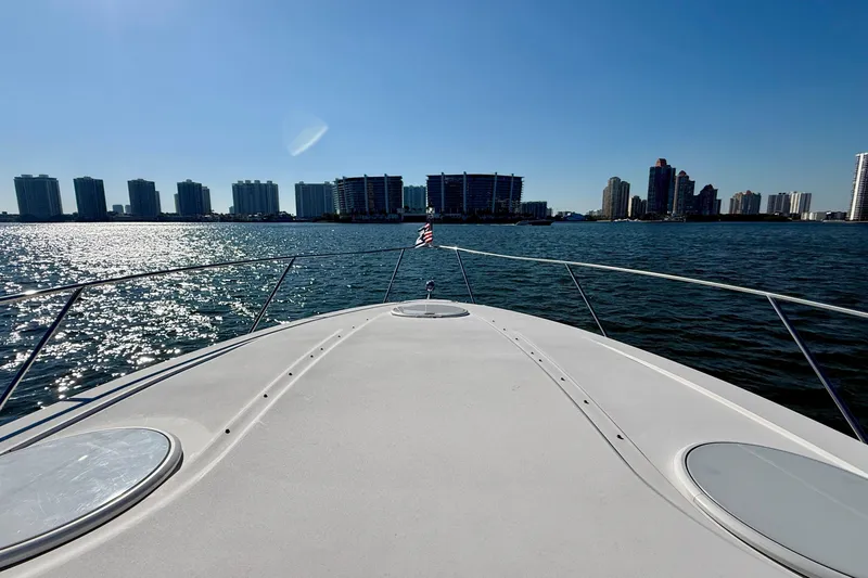 Slide: The Image of Bow view of 2005 Four Winns 378 Vista yacht cruising near city skyline. - 12