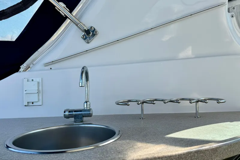 Slide: The Image of 2005 Four Winns 378 Vista boat sink and cup holder on deck. - 13