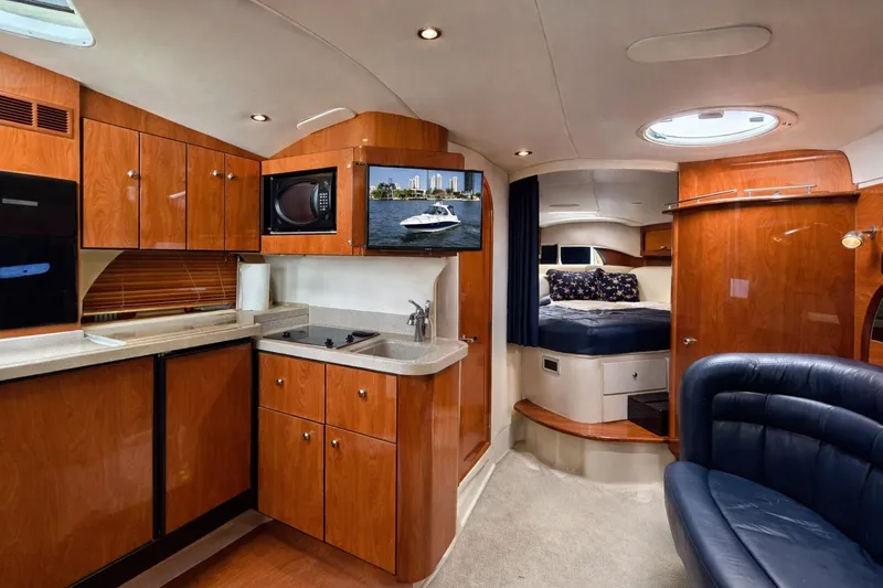 Slide: The Image of Luxurious interior of 2005 Four Winns 378 Vista yacht with kitchen and cozy sleeping area. - 15