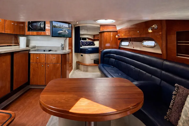 Slide: The Image of Luxurious interior of 2005 Four Winns 378 Vista yacht with wood finishes and leather seating. - 17