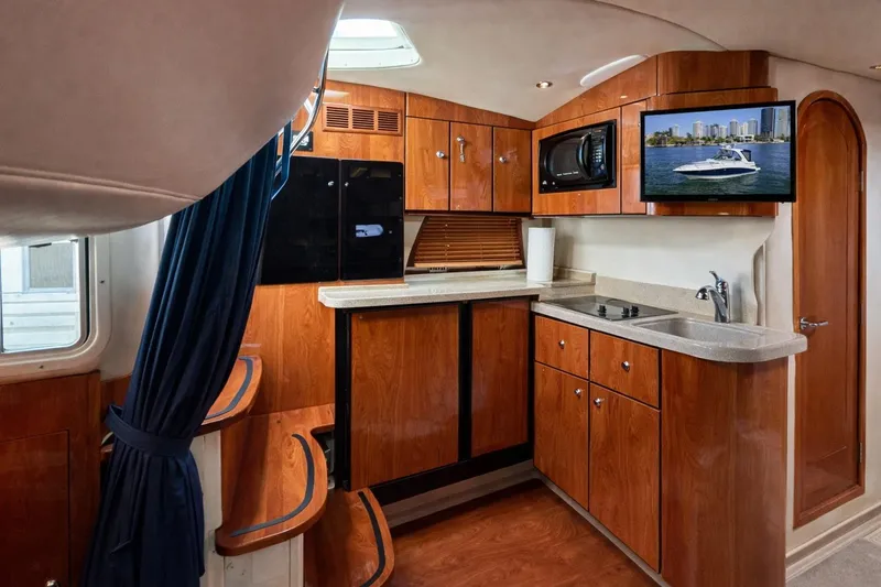 Slide: The Image of Interior of 2005 Four Winns 378 Vista yacht with modern kitchen amenities. - 18