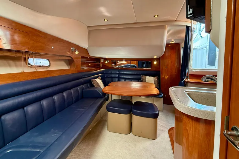 Slide: The Image of Luxurious 2005 Four Winns 378 Vista yacht interior with plush seating and elegant wood finishes. - 19