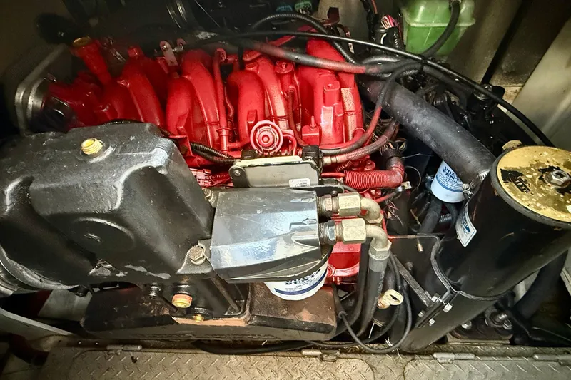 Slide: The Image of Engine compartment of a 2005 Four Winns 378 Vista boat, featuring a red engine block. - 22