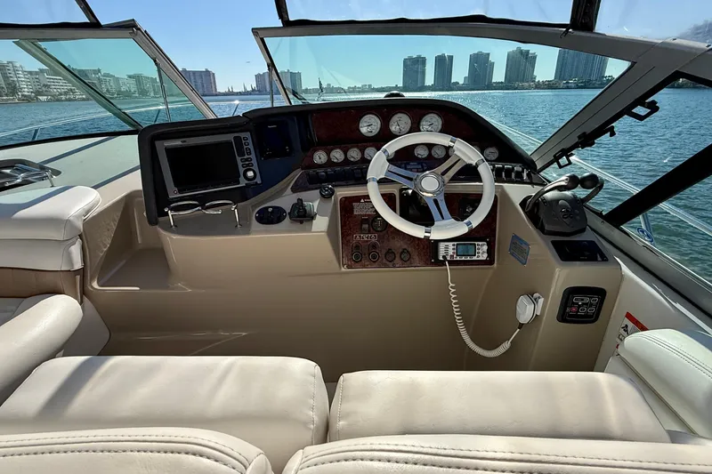 Slide: The Image of Helm of 2005 Four Winns 378 Vista yacht with city skyline view. - 6