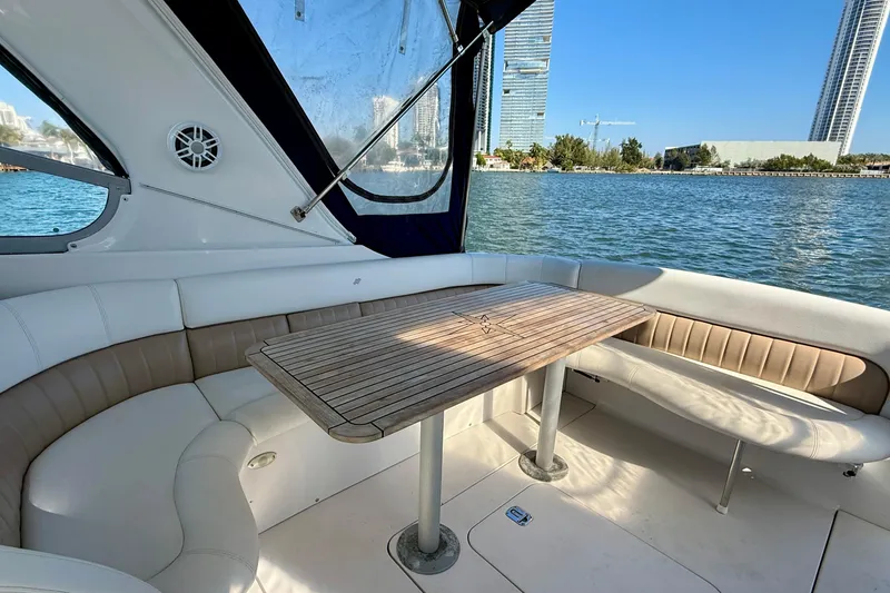 Slide: The Image of Interior of 2005 Four Winns 378 Vista yacht with seating and table, overlooking water and cityscape. - 9