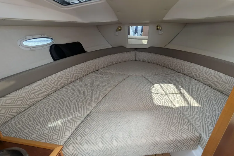 Slide: The Image of 2020 Cutwater C-24 Coupe interior cabin with patterned upholstery and natural light. - 11