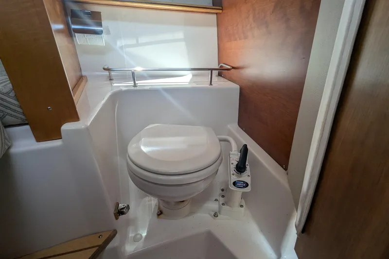 Slide: The Image of 2020 Cutwater C-24 Coupe boat bathroom with compact marine toilet. - 13