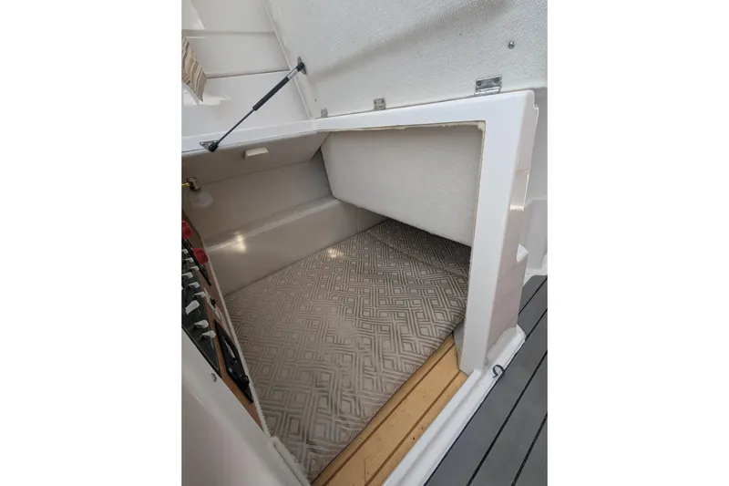 Slide: The Image of 2020 Cutwater C-24 Coupe interior storage compartment with patterned flooring. - 14
