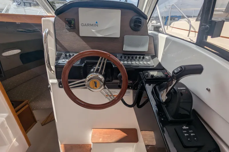 Slide: The Image of 2020 Cutwater C-24 Coupe helm with Garmin navigation and Yamaha controls. - 7