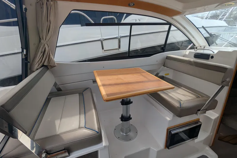Slide: The Image of Interior of 2020 Cutwater C-24 Coupe with seating and wooden table. - 9