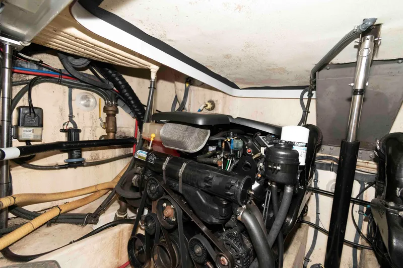 Slide: The Image of Engine room of a 2004 Formula 37 Performance Cruiser, showcasing mechanical components and wiring. - 19
