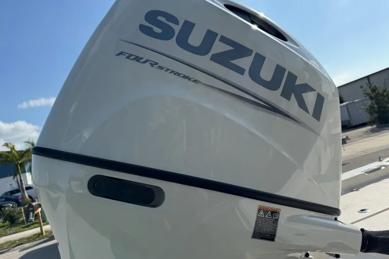 Slide: The Image of Trailer wheels of a 2023 Carolina Skiff 21 SWS on grass. - 14