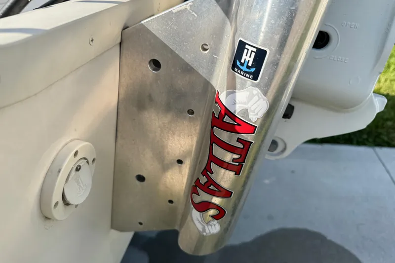 Slide: The Image of Close-up of a 2023 Carolina Skiff 21 SWS boat engine, outdoors with palm trees. - 20