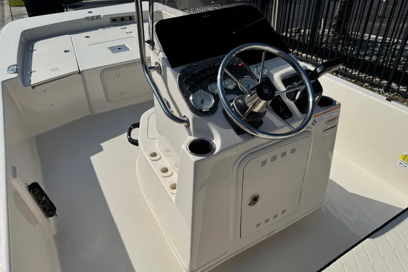 Slide: The Image of 2023 Carolina Skiff 21 SWS boat console with steering wheel and gauges. - 23
