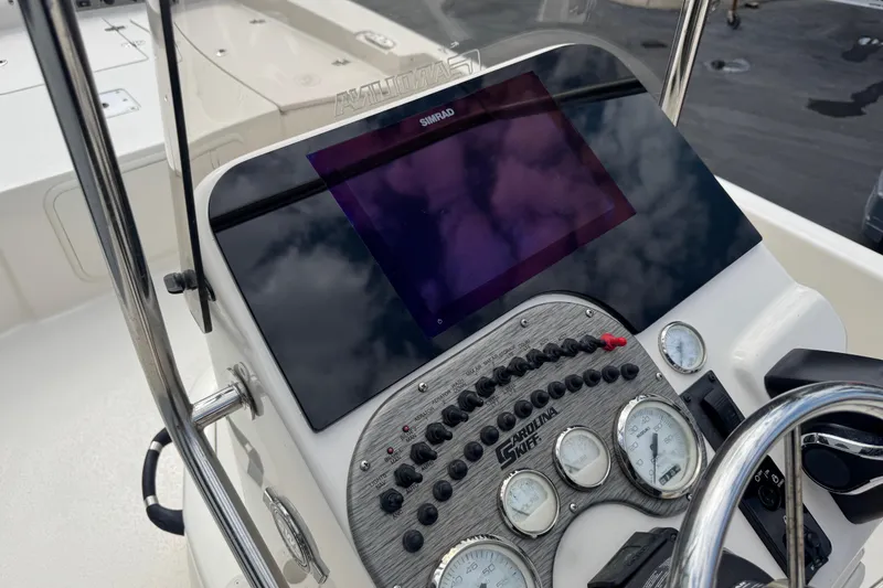Slide: The Image of 2023 Carolina Skiff 21 SWS boat console with steering wheel and controls. - 25