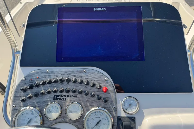 Slide: The Image of 2023 Carolina Skiff 21 SWS dashboard with Simrad display and control panel. - 26