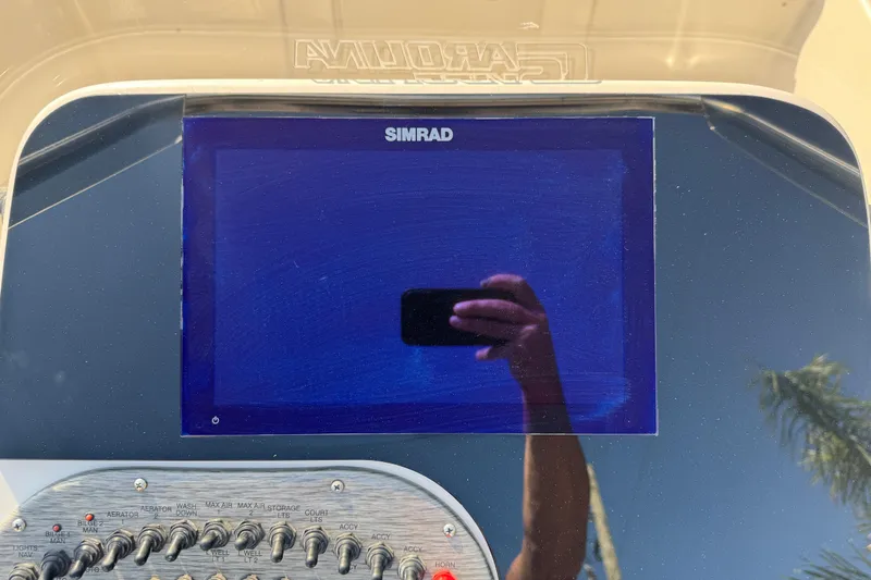 Slide: The Image of 2023 Carolina Skiff 21 SWS boat dashboard with gauges and steering wheel. - 27