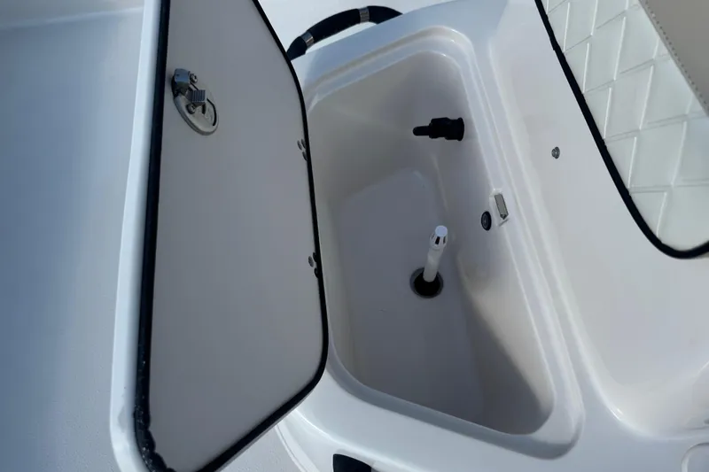 Slide: The Image of 2023 Carolina Skiff 21 SWS boat interior with cushioned seat and storage compartment. - 30