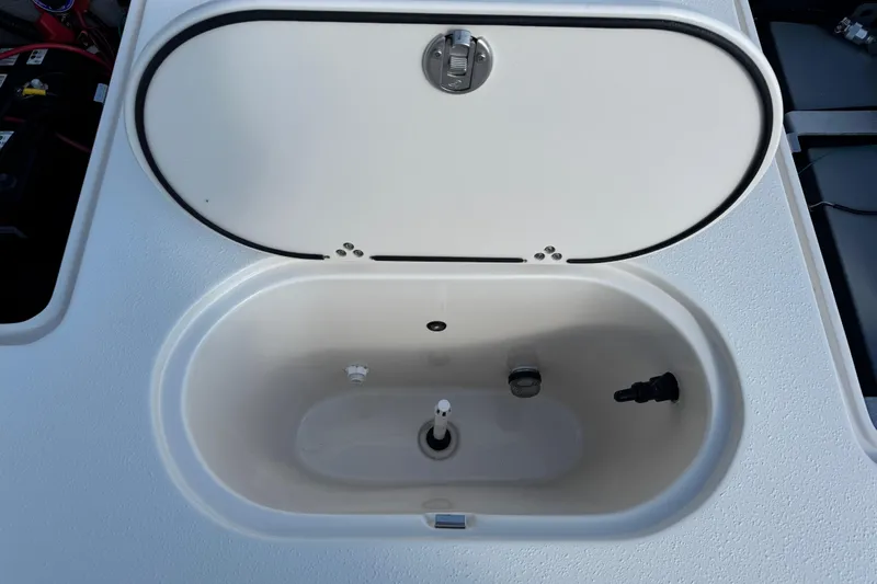 Slide: The Image of 2023 Carolina Skiff 21 SWS fuel cap on textured boat surface. - 37