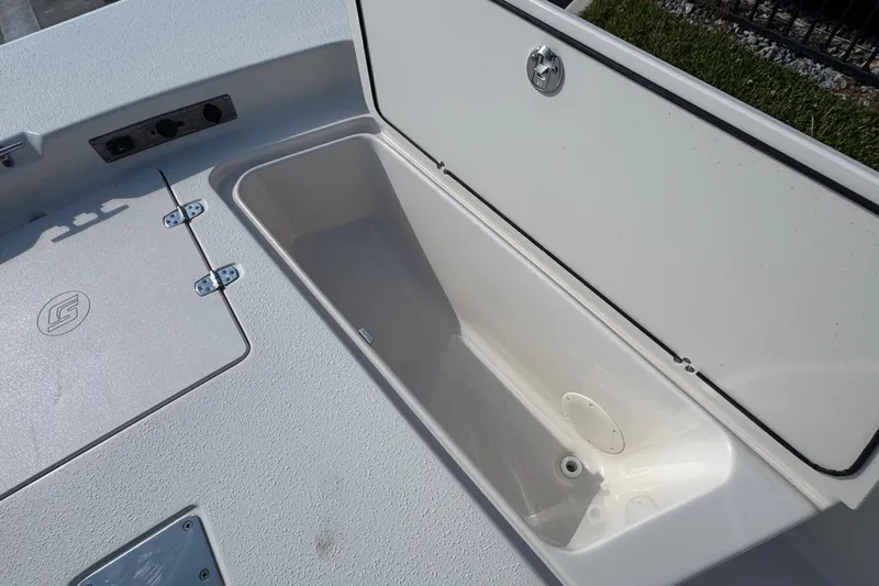 Slide: The Image of 2023 Carolina Skiff 21 SWS livewell with open lid, showcasing interior features. - 39