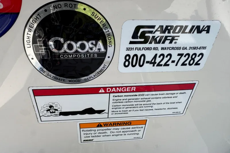 Slide: The Image of 2023 Carolina Skiff 21 SWS boat storage compartment with open lid, showcasing interior space. - 41