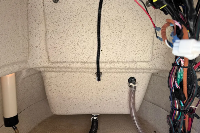 Slide: The Image of 2023 Carolina Skiff 21 SWS warning labels and contact information displayed on boat. - 43