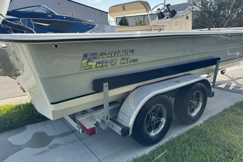 Slide: The Image of 2023 Carolina Skiff 21 SWS boat logo on white surface. - 5