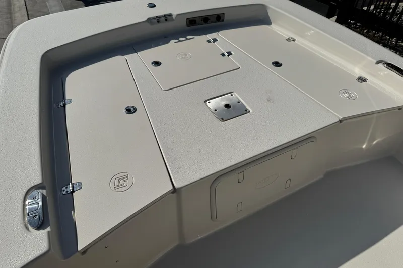 Slide: The Image of 2023 Carolina Skiff 21 SWS boat with logo, parked outdoors on a sunny day. - 52