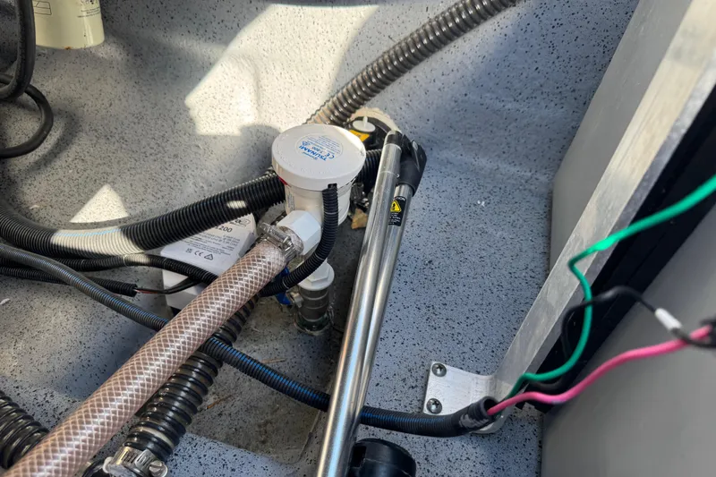 Slide: The Image of 2023 Carolina Skiff 21 SWS boat deck with storage compartments and control panel. - 64