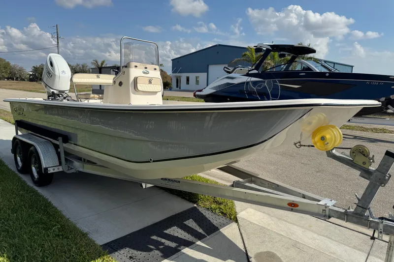 Slide: The Image of 2023 Carolina Skiff 21 SWS boat on a trailer, parked outdoors. - 7