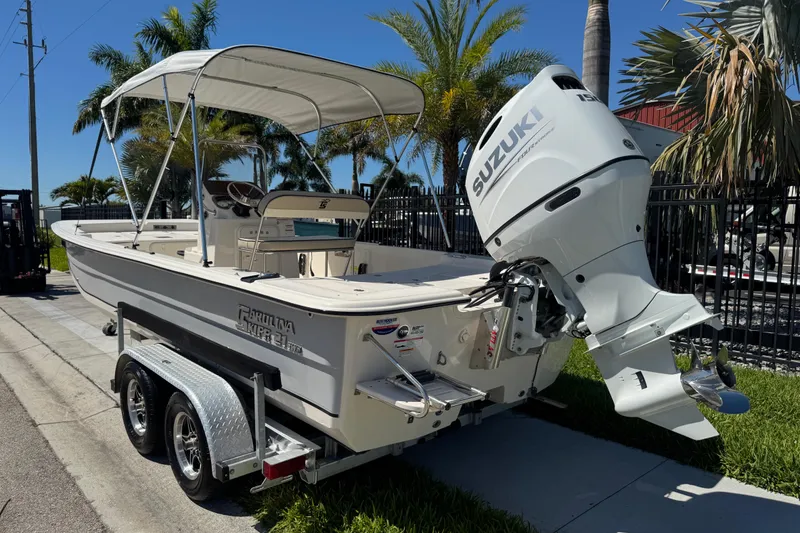 Slide: The Image of 2023 Carolina Skiff 21 SWS boat with Suzuki outboard motor on trailer. - 80