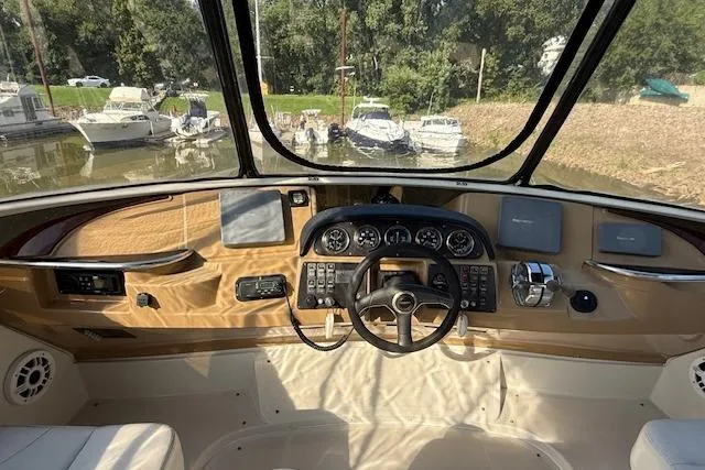 Slide: The Image of Helm of 2001 Carver 396 Aft Cabin Motor Yacht with control panel and steering wheel. - 2