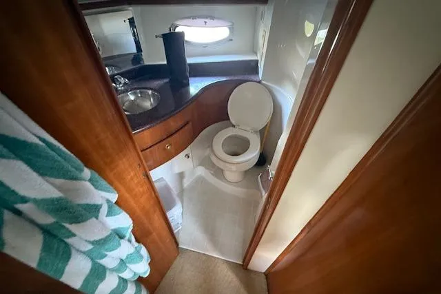 Slide: The Image of Bathroom interior of 2001 Carver 396 Aft Cabin Motor Yacht, featuring sink and toilet. - 4