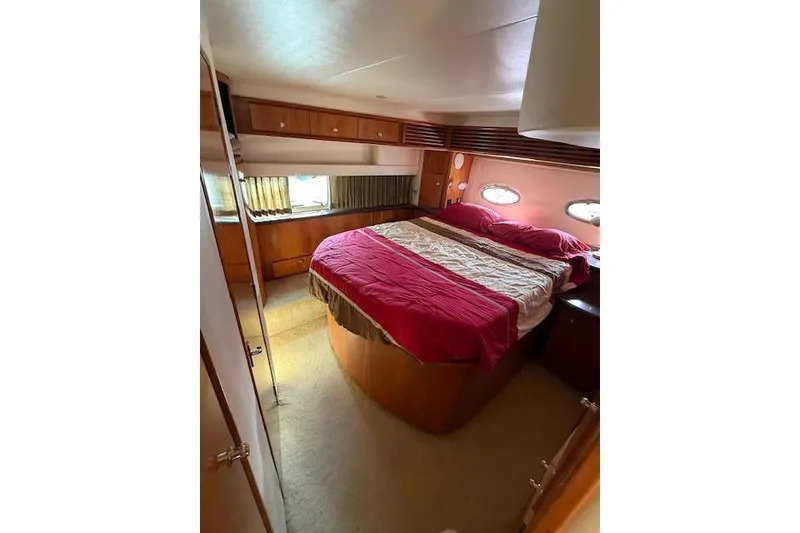 Slide: The Image of Interior of 2001 Carver 396 Aft Cabin Motor Yacht with cozy bedroom and porthole windows. - 7