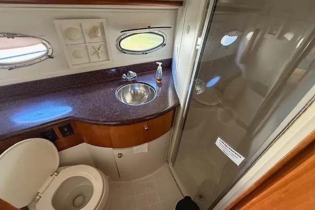 Slide: The Image of 2001 Carver 396 Aft Cabin Motor Yacht bathroom with sink, toilet, and shower. - 8