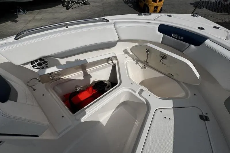 Slide: The Image of 2021 Robalo R227 Dual Console boat interior with open storage compartments. - 10