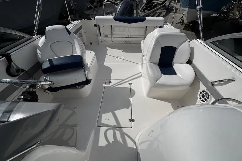 Slide: The Image of 2021 Robalo R227 Dual Console boat interior with white and blue seating. - 11