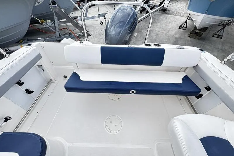 Slide: The Image of 2021 Robalo R227 Dual Console boat interior with blue and white seating. - 22