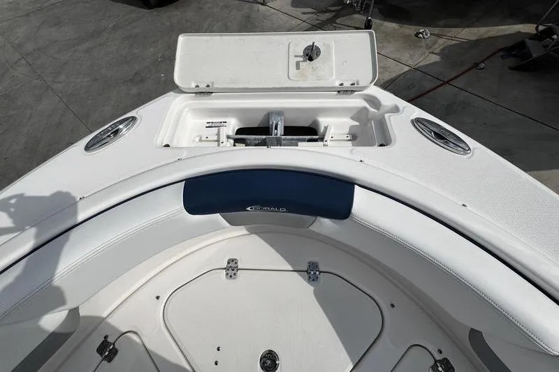 Slide: The Image of 2021 Robalo R227 Dual Console boat bow with anchor storage and seating area. - 5