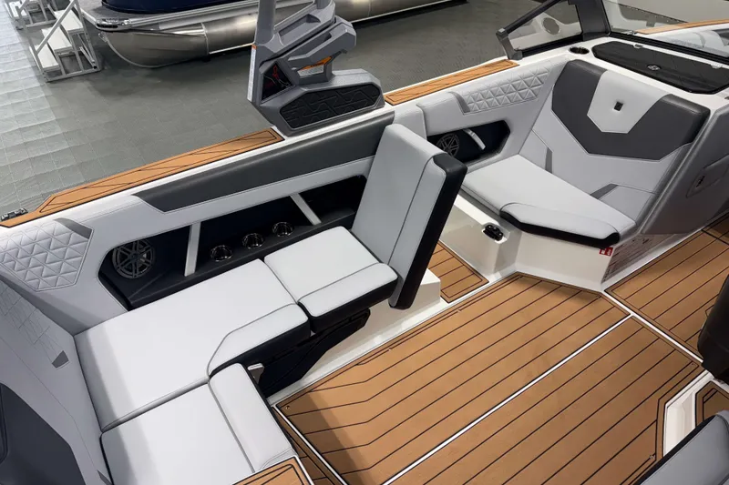 Slide: The Image of 2026 Nautique Super Air Nautique GS22 interior with modern seating and teak flooring. - 12