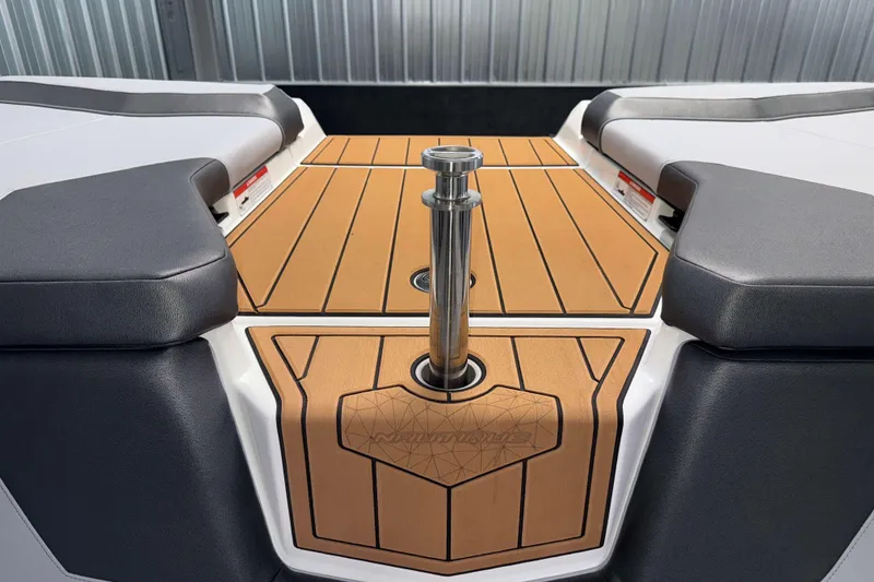 Slide: The Image of 2026 Nautique Super Air Nautique GS22 boat interior with teak deck and cushioned seating. - 14