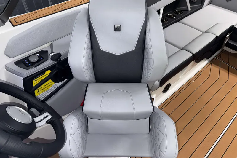 Slide: The Image of 2026 Nautique Super Air Nautique GS22 interior with sleek captain's chair and modern controls. - 17