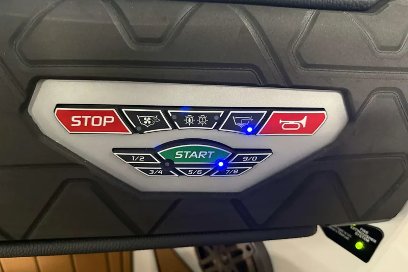Slide: The Image of Control panel of 2026 Nautique Super Air Nautique GS22 with start and stop buttons. - 21