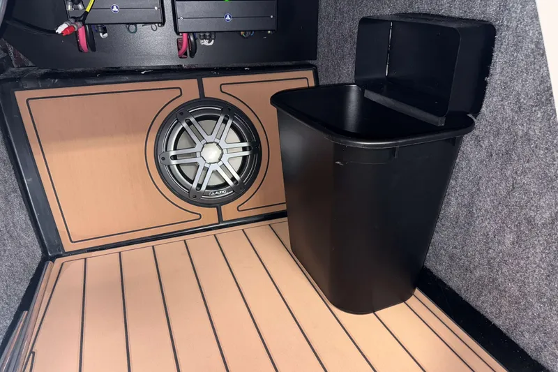 Slide: The Image of 2026 Nautique Super Air Nautique GS22 interior with speaker and storage bin. - 24